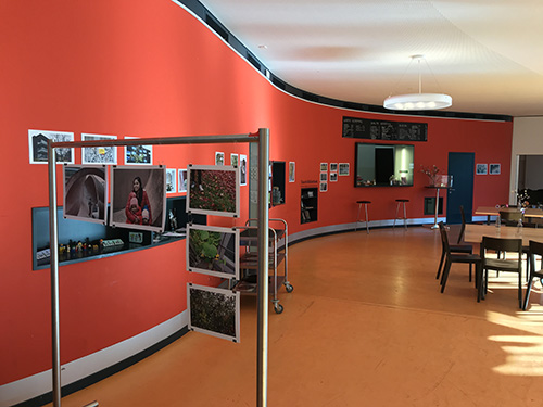 community center cafe with photography exhibition on the walls