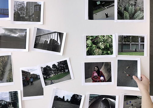 image results of a photography workshop on a table, one hand holding a photo