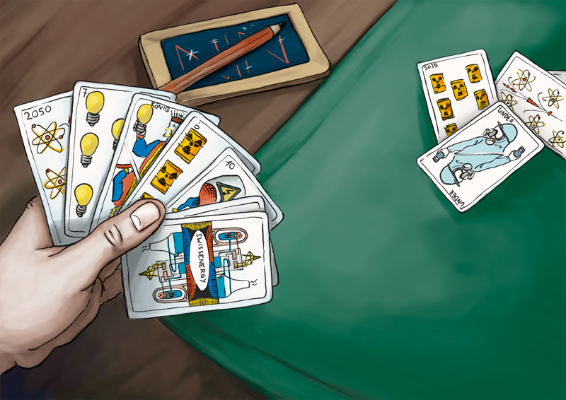 hand with playing cards that show thematic of energy production